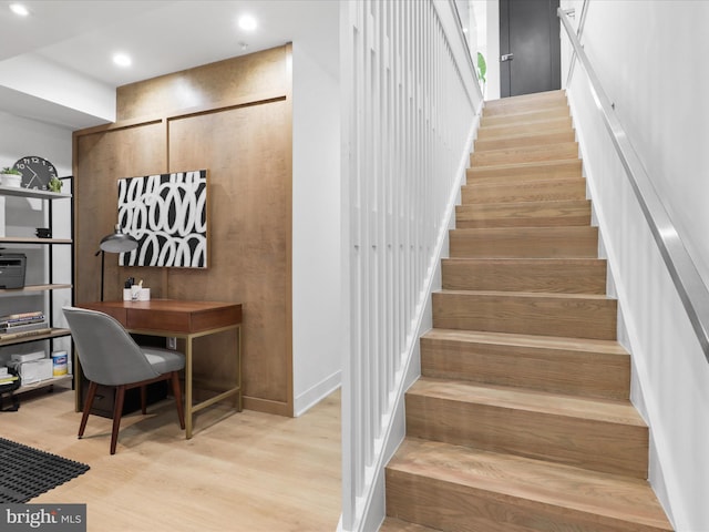 stairs featuring hardwood / wood-style flooring