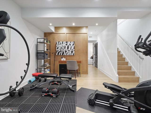 exercise room with light hardwood / wood-style flooring