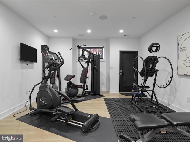 exercise room with hardwood / wood-style floors