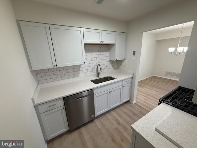 kitchen with dishwasher, white cabinets, sink, light hardwood / wood-style flooring, and tasteful backsplash