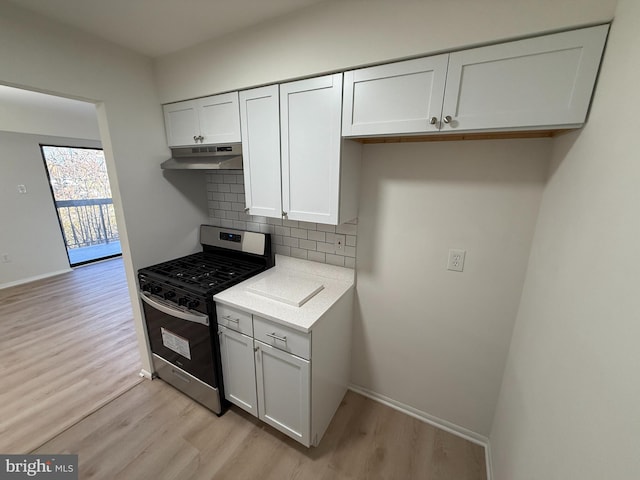 kitchen featuring white cabinets, decorative backsplash, light wood-type flooring, and stainless steel gas range