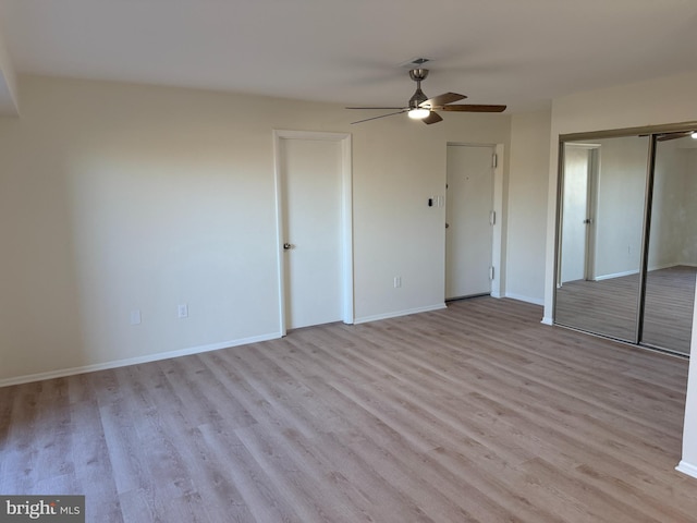 unfurnished bedroom with ceiling fan and light wood-type flooring