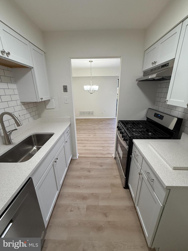 kitchen with white cabinetry, sink, light hardwood / wood-style flooring, and appliances with stainless steel finishes