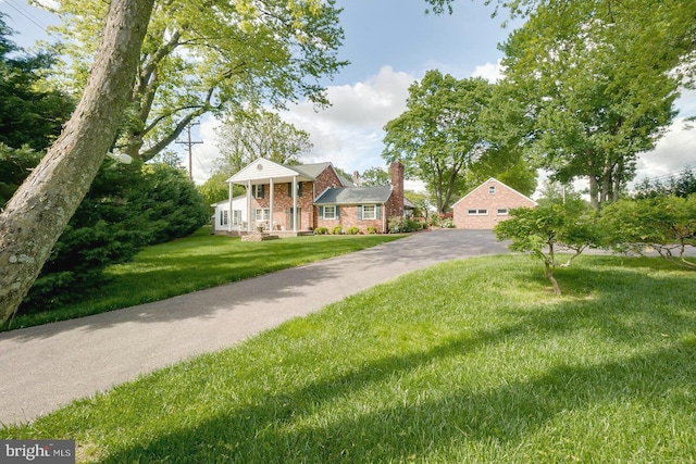 view of front of house with a front yard and a porch