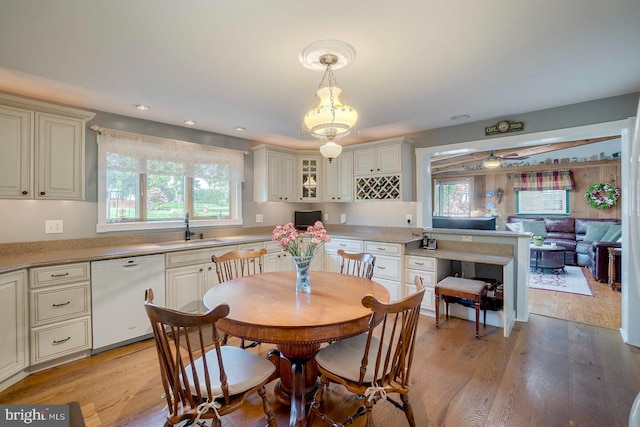 dining area featuring sink and light hardwood / wood-style flooring