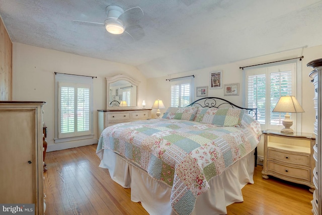 bedroom featuring multiple windows, ceiling fan, and light wood-type flooring