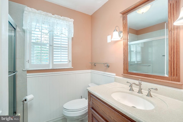 bathroom with vanity, toilet, and an enclosed shower