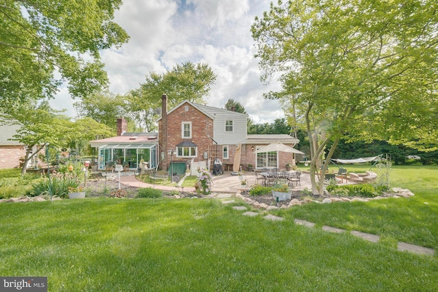 back of property featuring a patio area and a lawn