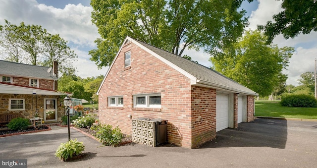 view of home's exterior with a garage and an outdoor structure