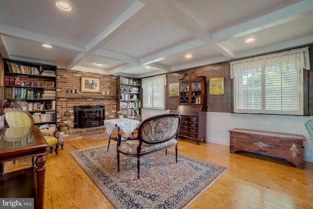 living room featuring light hardwood / wood-style floors, a wealth of natural light, and coffered ceiling