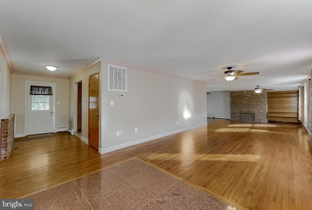 unfurnished living room with hardwood / wood-style flooring, baseboard heating, and crown molding