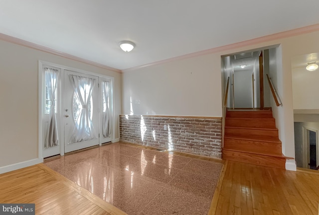 foyer entrance with hardwood / wood-style flooring and ornamental molding