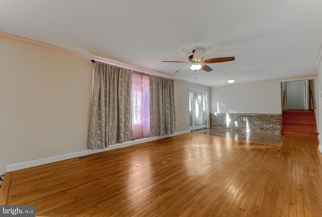 unfurnished room featuring ceiling fan, light hardwood / wood-style floors, and crown molding