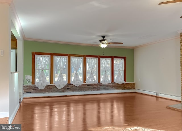 empty room featuring light hardwood / wood-style floors, plenty of natural light, and crown molding