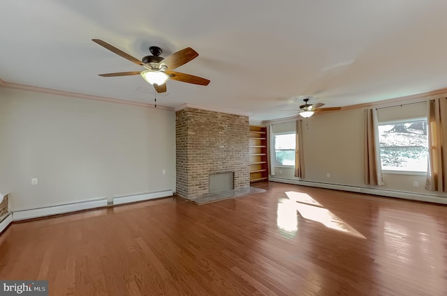 unfurnished living room featuring baseboard heating, a fireplace, plenty of natural light, and hardwood / wood-style floors