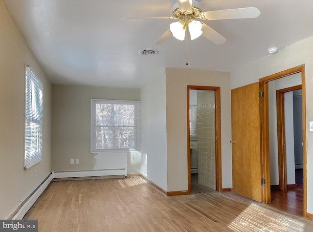 unfurnished bedroom featuring light hardwood / wood-style floors, a baseboard radiator, and ceiling fan