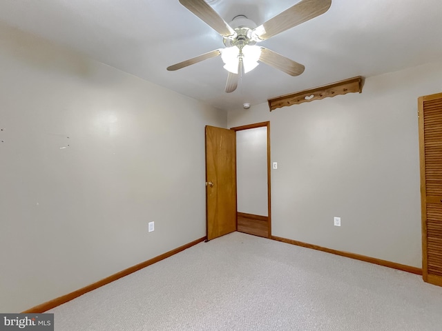 spare room featuring ceiling fan and carpet floors