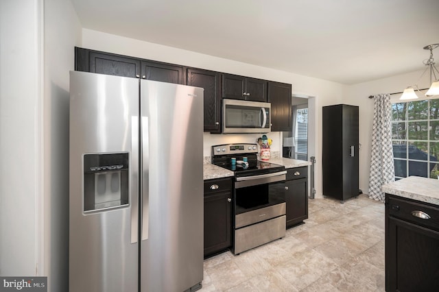 kitchen with pendant lighting and appliances with stainless steel finishes