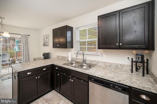 kitchen with kitchen peninsula, dishwasher, hanging light fixtures, and sink