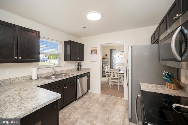 kitchen featuring pendant lighting, sink, and stainless steel appliances