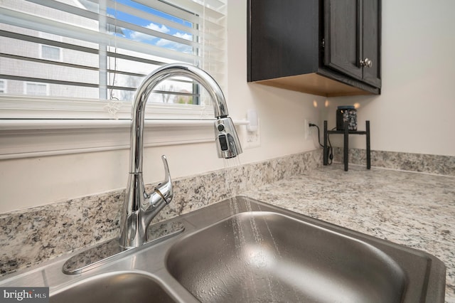 details with light stone countertops and sink