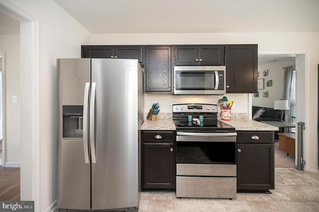 kitchen with dark brown cabinets and appliances with stainless steel finishes