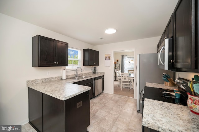 kitchen with dark brown cabinets, stainless steel appliances, and sink