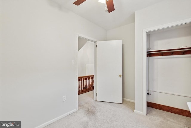 unfurnished bedroom with light carpet, a closet, and ceiling fan