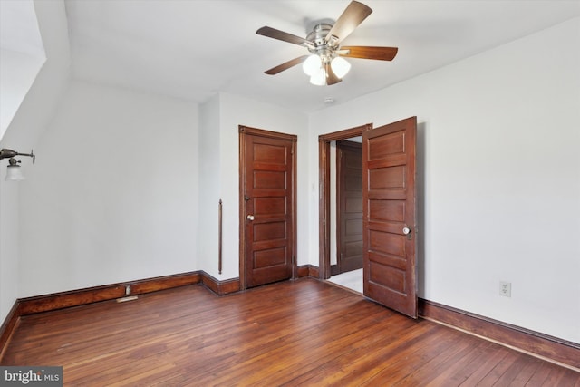 unfurnished bedroom featuring ceiling fan and dark hardwood / wood-style flooring