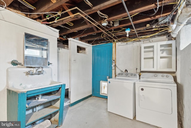 basement featuring separate washer and dryer and sink