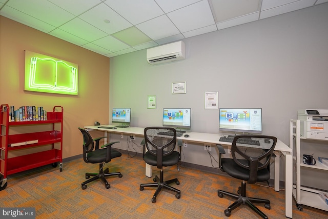 office space featuring a wall mounted air conditioner and a drop ceiling