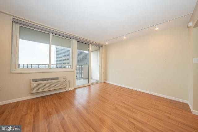 1901 John F Kennedy Blvd Unit 2305, Philadelphia, PA 19103 - spare room featuring track lighting, a wall unit AC, wood finished floors, and baseboards