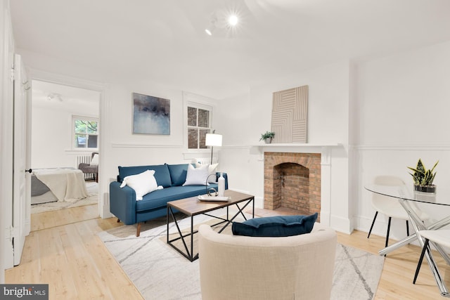 living room with hardwood / wood-style flooring and a fireplace