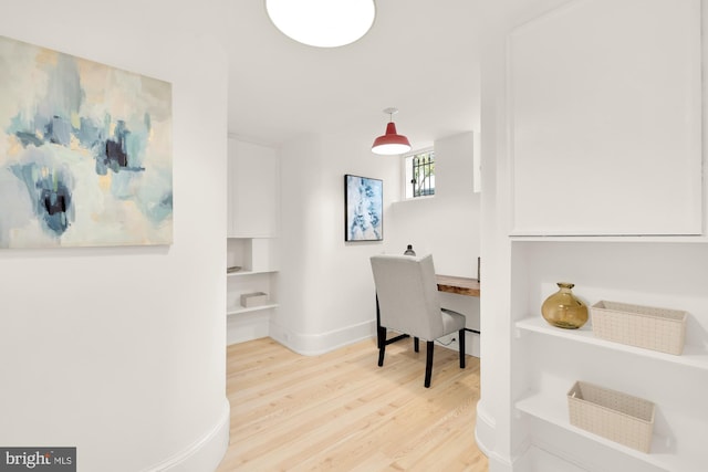 home office with wood-type flooring