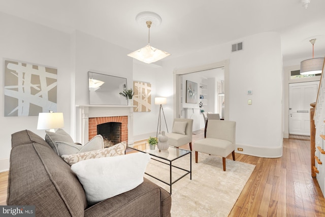 living room featuring light hardwood / wood-style flooring and a fireplace