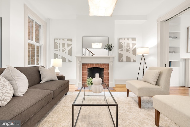 living room with hardwood / wood-style flooring and a fireplace