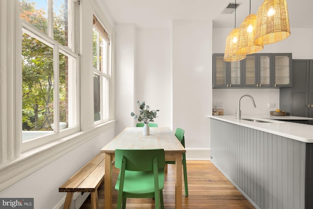 dining space featuring sink and light hardwood / wood-style flooring