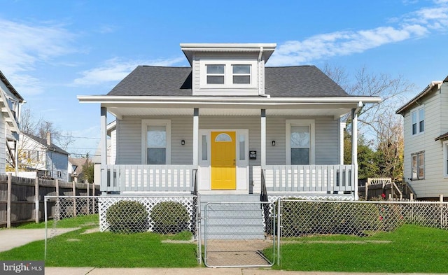 bungalow-style home with a front yard and a porch