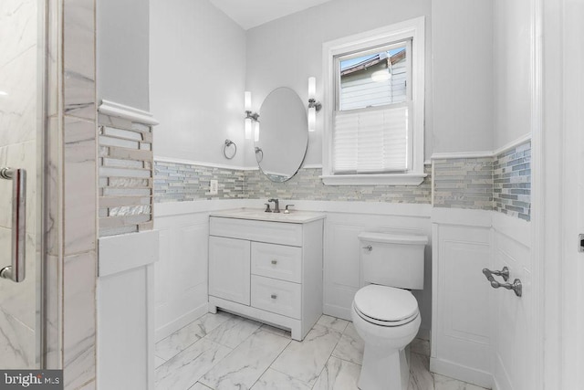 bathroom featuring decorative backsplash, vanity, and toilet