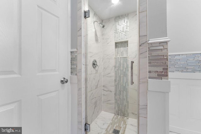 bathroom featuring a shower with shower door