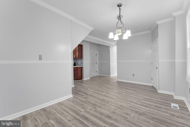 interior space featuring ornamental molding, light hardwood / wood-style floors, and a notable chandelier