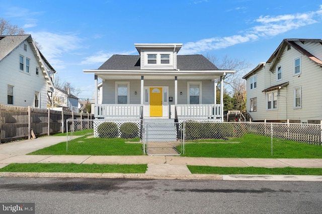 bungalow-style home with covered porch and a front yard