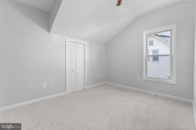 additional living space featuring carpet flooring, ceiling fan, and vaulted ceiling