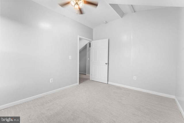 carpeted empty room featuring ceiling fan and lofted ceiling