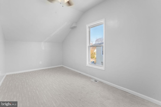 additional living space featuring carpet flooring, ceiling fan, and lofted ceiling