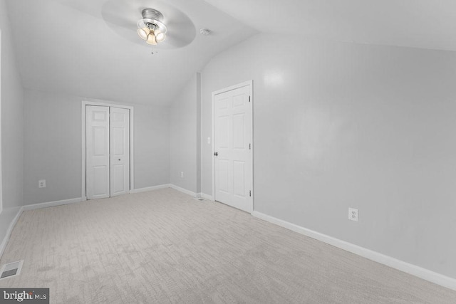 bonus room with ceiling fan, light colored carpet, and vaulted ceiling