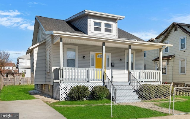 bungalow-style house with a front lawn and a porch