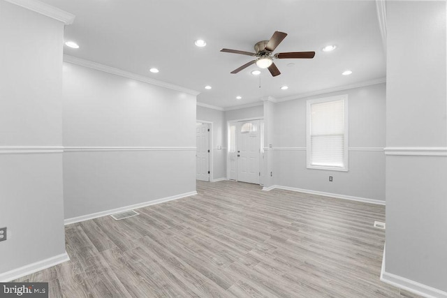 empty room with ceiling fan, light wood-type flooring, and crown molding