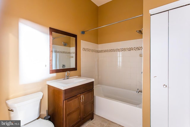 full bathroom featuring tile patterned flooring, vanity, toilet, and tiled shower / bath combo