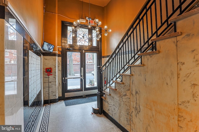 entryway featuring a high ceiling and a notable chandelier